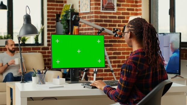 Office worker analyzing isolated greenscreen template on personal computer