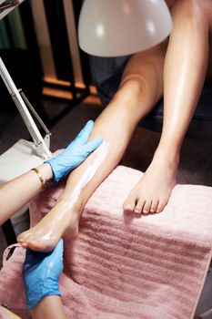 legs of a woman receiving a moisturizing massage