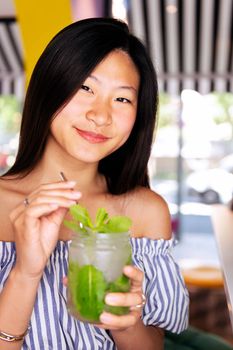 young woman smiling happy drinking refreshing soda