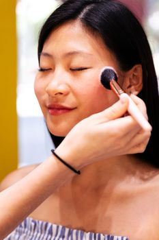 portrait of a woman receiving a professional makeup