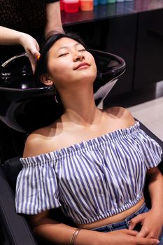 woman washing her hair at the hairdressing salon