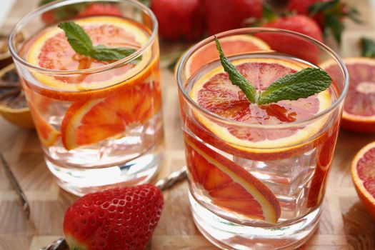 Water infused with citrus and mint leaves. closeup