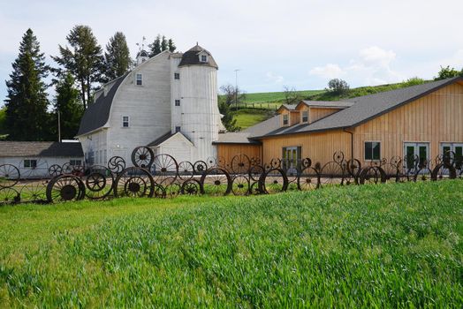 a barn with wheel fence