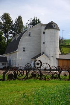 a barn with wheel fence