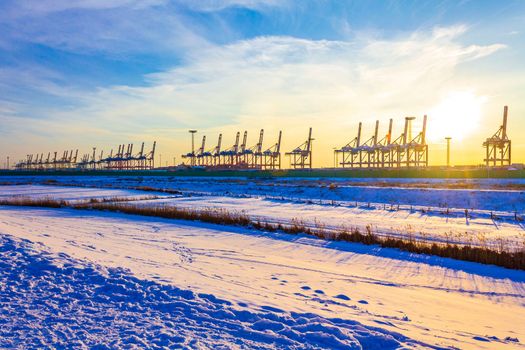 Shipyard cranes shipyard crane sunset winter container port Bremerhaven Germany.