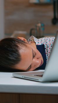 Exhausted business woman falling asleep on desk