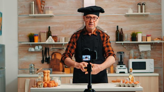 Senior man creating content for culinary blog