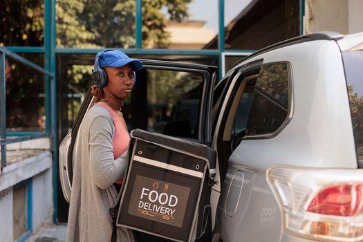 African american courier delivering office food by car portrait