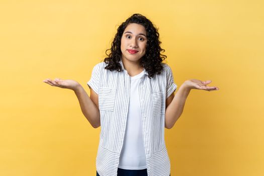 Woman standing with raised arms, looking away and don't know what to do.
