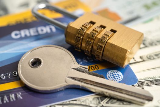 Credit card with password key lock security on US dollar background.