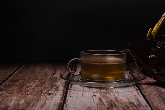 teacup and teapot pouring hot tea