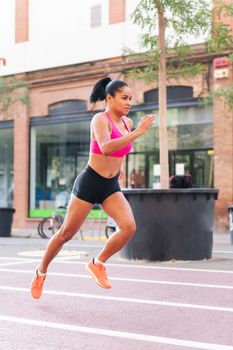 sportswoman running during her workout at city