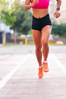 legs of sportswoman running on the athletics track