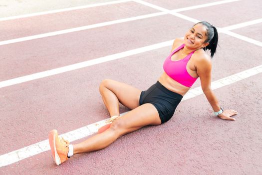 athlete rests on the athletics track after workout