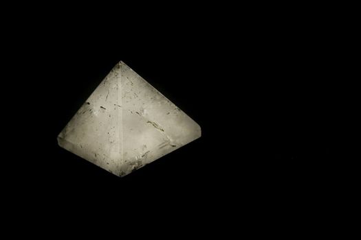quartz pyramid on black background
