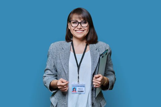 Confident woman with education center card on blue background