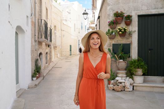 Beautiful young joyful woman enjoying her summer holidays in Monopoli, Apulia, Italy