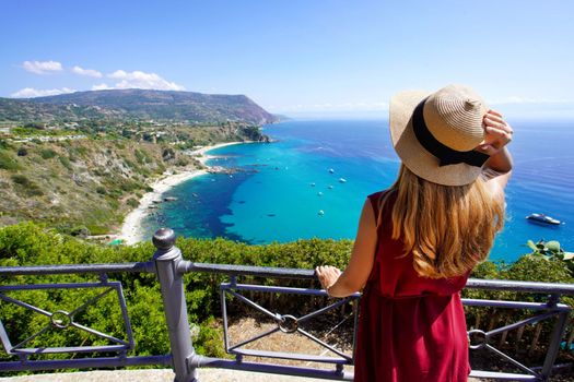Holidays in Italy. Rear view of traveler woman in Capo Vaticano on Coast of the Gods, Calabria, Italy.