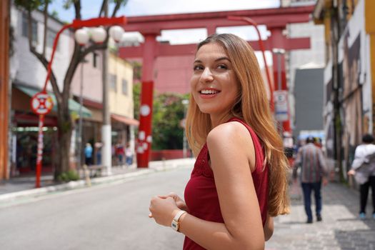 Portrait of beautiful confident smiling woman in Sao Paulo japanese neighborhood Liberdade, Sao Paulo, Brazil