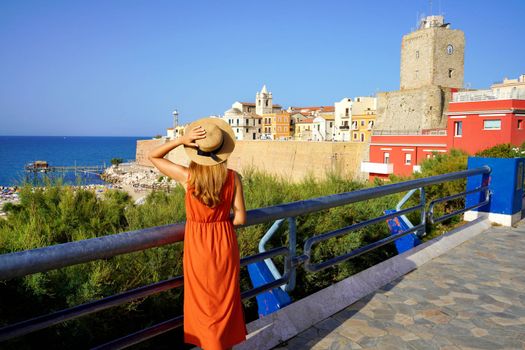Tourist woman in Termoli with historic town fortified and castle in Molise, Italy