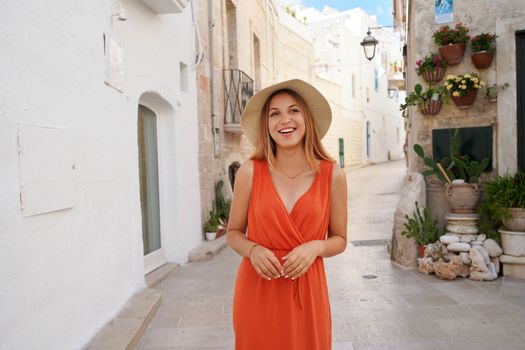 Attractive young joyful woman enjoying her summer holidays in Apulia, Italy