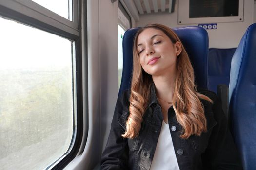 Beautiful woman sleeping sitting on public transport on autumn season