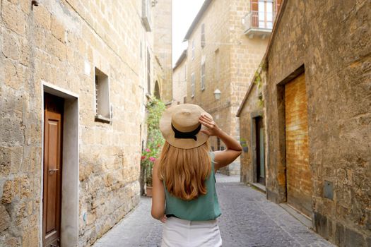Holidays in Italy. Young woman visiting historic medieval town of Orvieto, Umbria, Italy.