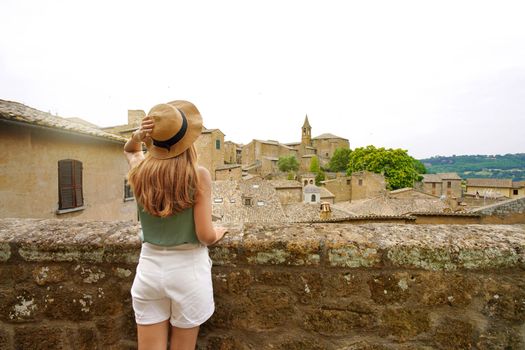 Beautiful tourist girl visiting the historic village of Orvieto, Umbria, Italy