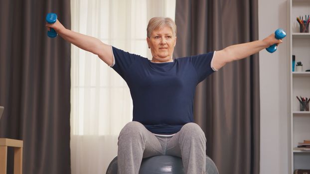 Senior woman exercising with dumbbells