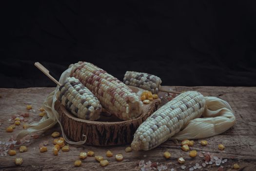 Fresh waxy corn or Sweet glutinous corn and Corn kernelson Rustic old wooden background. 