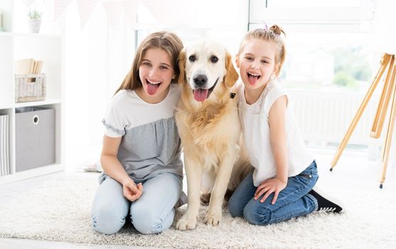 Smiling sisters with cute dog