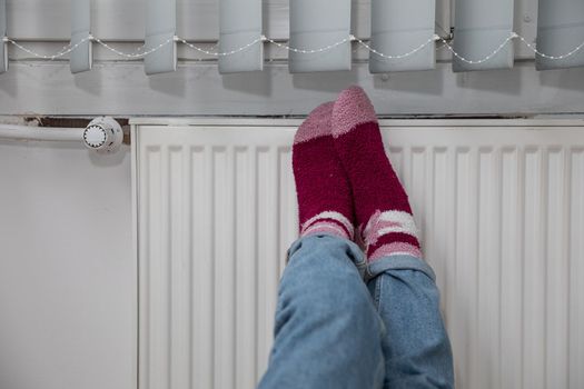 Warming cold feet on a hot radiator. Thick wool socks.