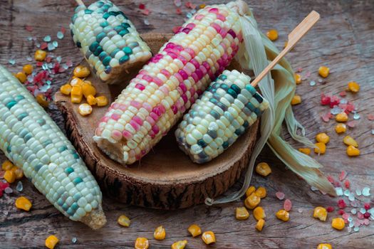 Fresh waxy corn or Sweet glutinous corn and Corn kernelson Rustic old wooden background. 