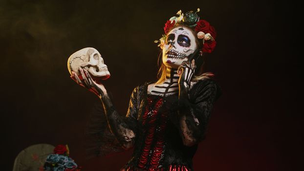 Mexican horror goddess on phone call holding skull