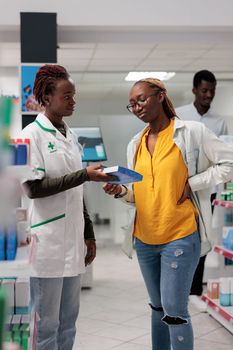 Customer buying back pain medication in drugstore