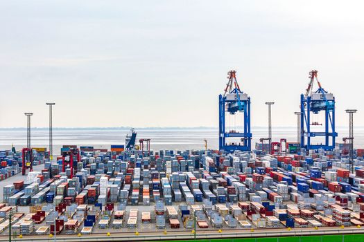 Industrial area cranes container dyke seascape panorama in Bremerhaven Germany.
