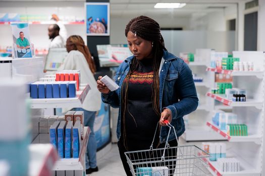 African american woman checking prescription treatment in pharmacy