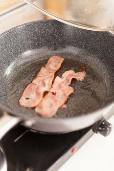Fried bacon in the pan