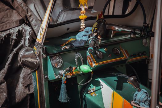 Dashboard and steering wheel and shift lever inside Thai traditional taxi or Three wheels vehicle  (3-wheeler taxi). Tuk-Tuk car interior design.