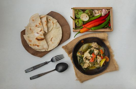 Homemade pita bread served with Green curry chicken.