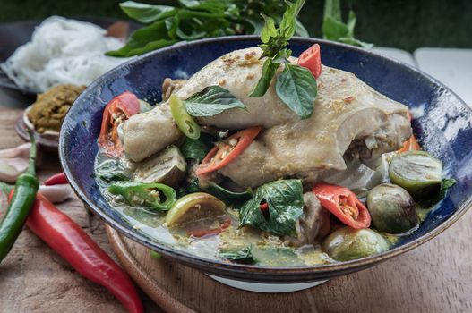 Green curry with Chicken and Green-white varieties of Thai eggplants (Kaeng khiao wan) in Ceramic bowl. 