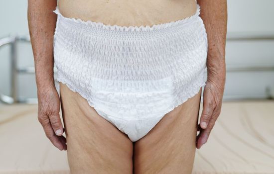 Asian elder senior woman patient wearing adult incontinence diaper pad in hospital.