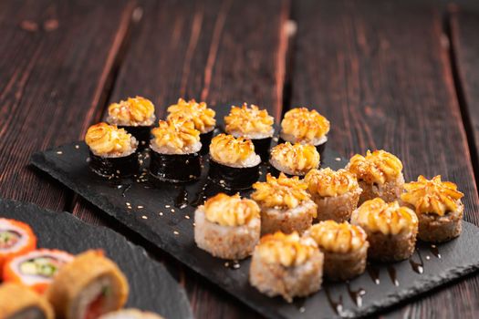 Japanese salmon sushi with spicy mayonnaise - Sushi menu norimaki and uramaki. Asian cuisine concept