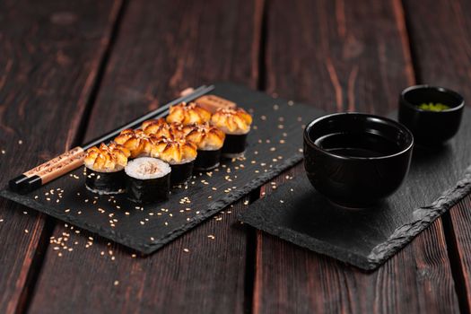 Japanese hot maki roll sushi with eel close-up - asian food concept