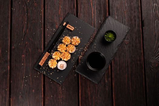 Maki sushi roll with eel served on black board top view - Japanese food