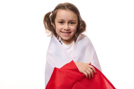Little European Polish citizen, lovely baby girl wrapping flag of Poland, celebrates Independence Day on November 11th