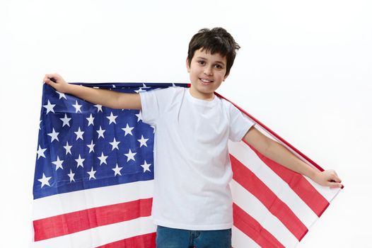 Adorable American preteen boy carries USA flag, celebrates Independence day on July 4. Citizenships. Immigration concept