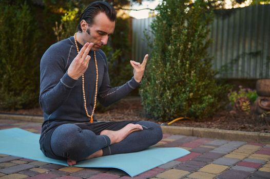 Peaceful confident man athlete, yogi during a meditation outdoors.Yoga practice