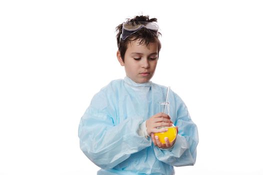 Confident teenage boy in labwear with a laboratory flask and glass stick, isolated over white backgound