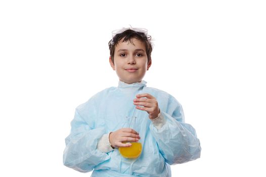Confident portrait on white background of a smart teenage schoolboy, a young chemist with a glass flask with chemicals